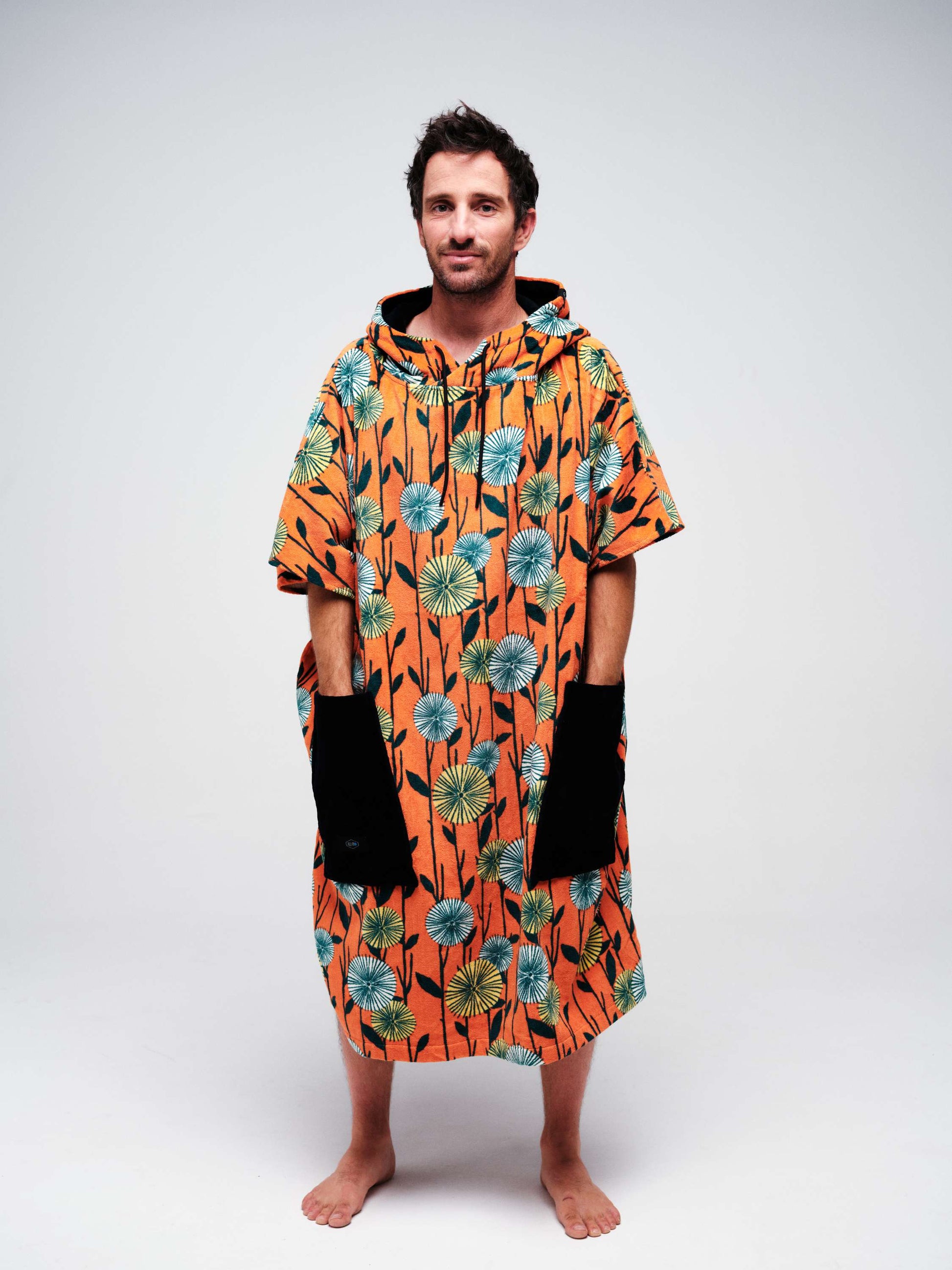 Poncho de surf adulte ALL-IN coupe V-Shape modèle Dandelion orange à motifs fleurs.